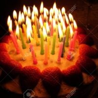 birthday strawberry cake with lighted candles