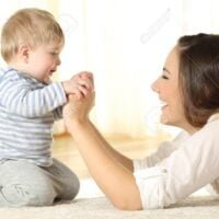 Profile of a mother and her kid son holding hands