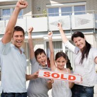 Portrait of happy young family celebrating buying their new house