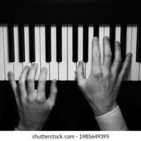 isolated-hands-playing-on-piano-260nw-1985649395