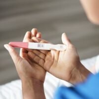 midsection-of-woman-holding-pregnancy-test-in-home-royalty-free-image-1677517706