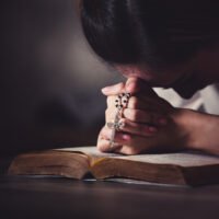 persona-rezando-el-rosario-en-silencio